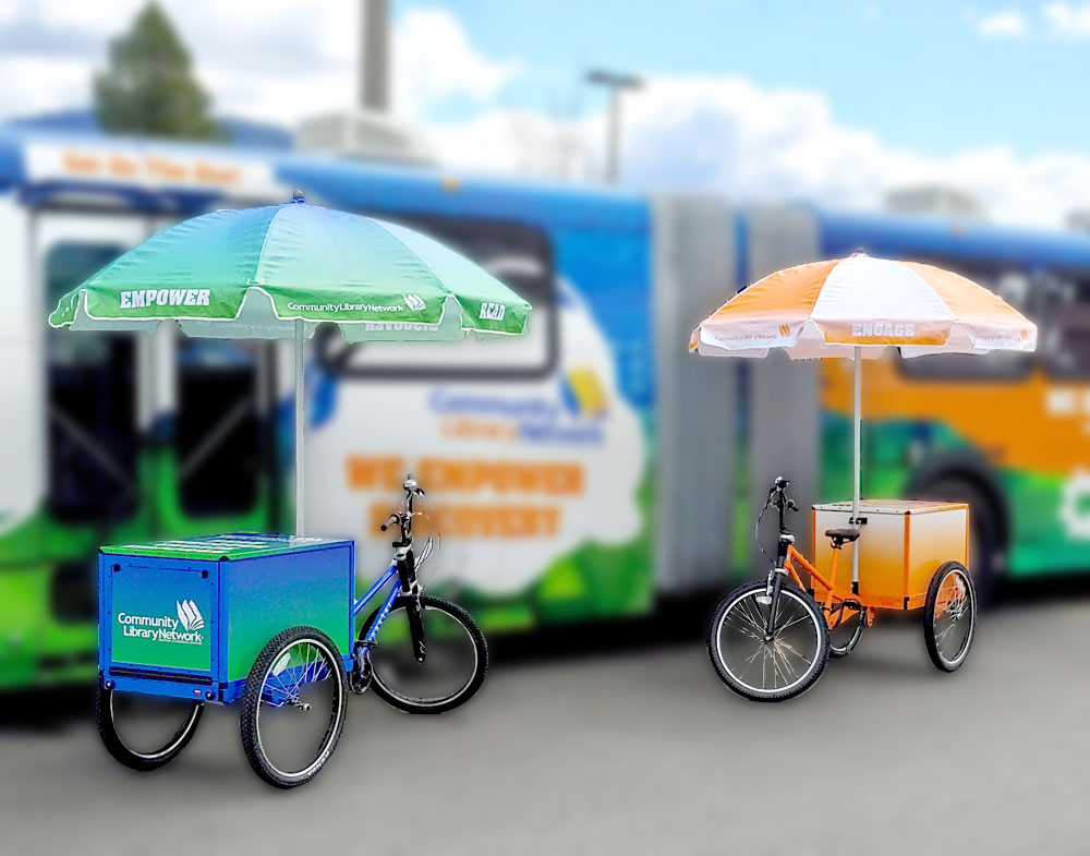 two tricycle bikes with book cabinet on the back